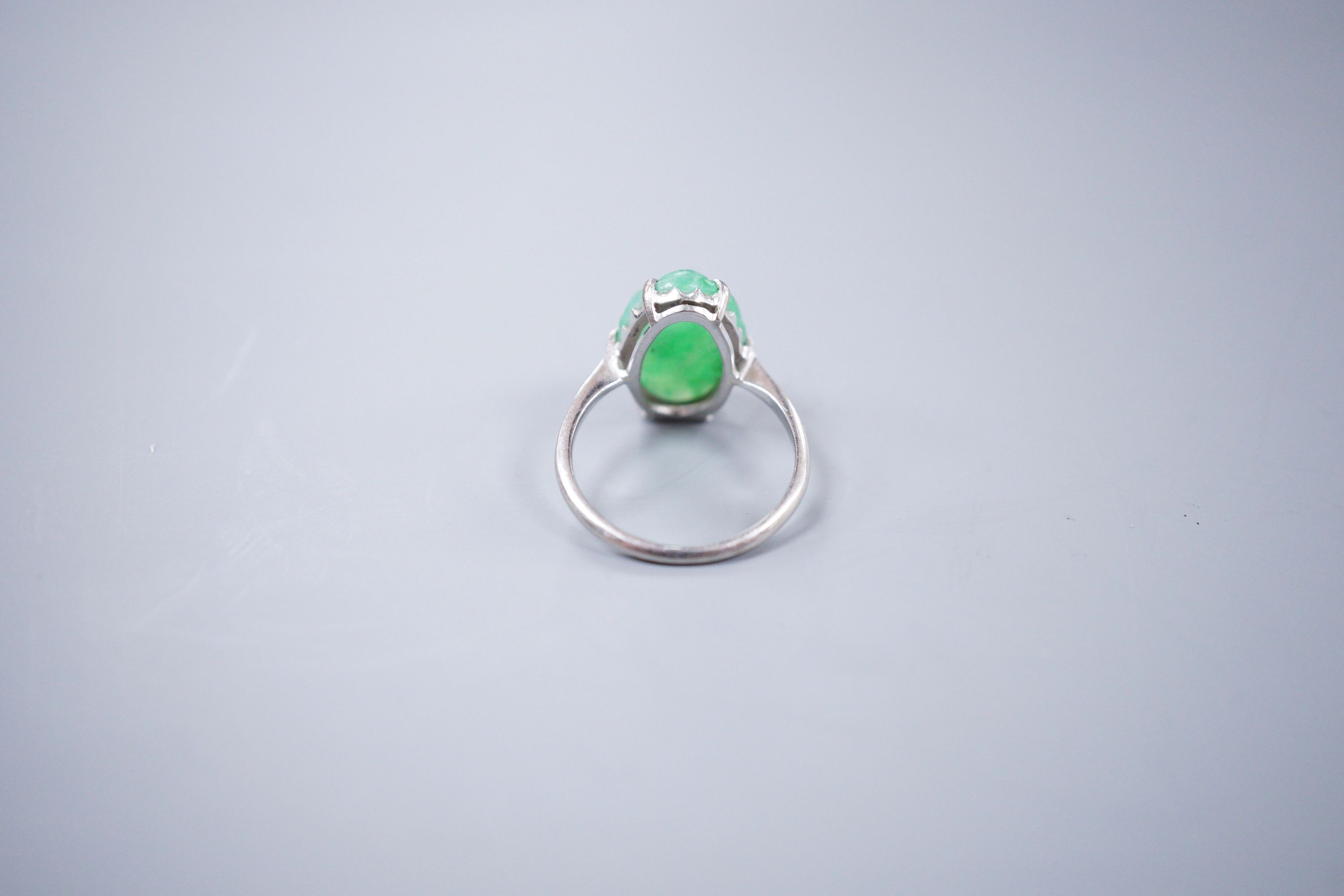 An 18ct white gold and carved jade dress ring, size M, gross 3.9 grams